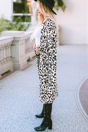 Leopard print duster cardigan with long sleeves and an open front, styled with a white top and black boots.