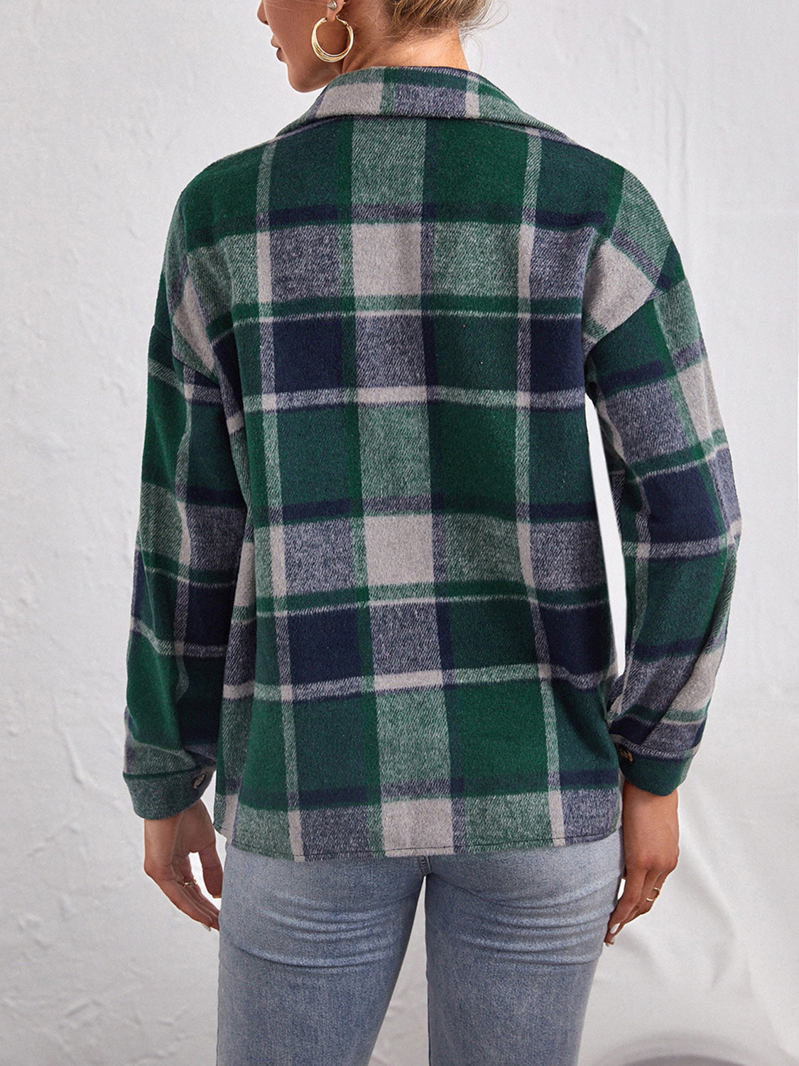 Oversized dark green plaid shacket with button closure, long sleeves, and collar.