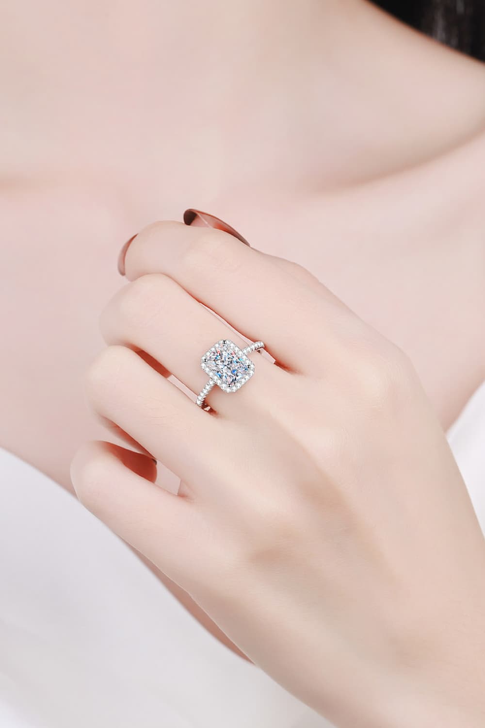 Radiant cushion cut halo ring in silver with a sparkling center stone and diamond-accented band.