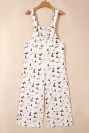 White cotton jumpsuit with desert and horse print, adjustable straps, cropped legs.