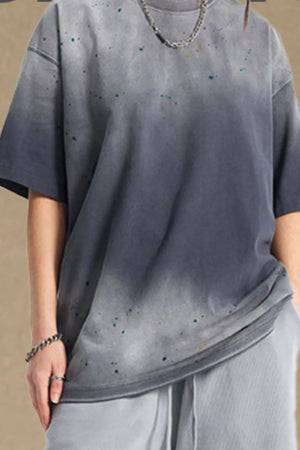 Oversized gray t-shirt with paint splatter detail and crew neck.