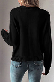 Black knit cardigan with mesh detail on the sleeves.