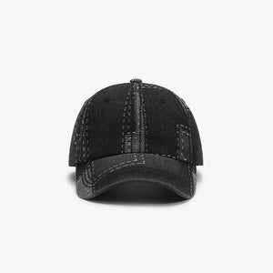 Black denim patchwork baseball cap with contrast stitching details.