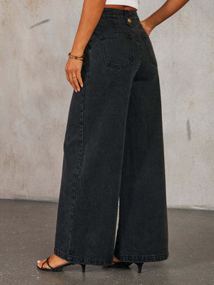 Dark wash denim wide-leg jeans with button detail and a high waist.