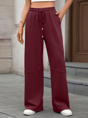 Wine Red high-waist drawstring wide-leg pants with pockets and paneled detail.