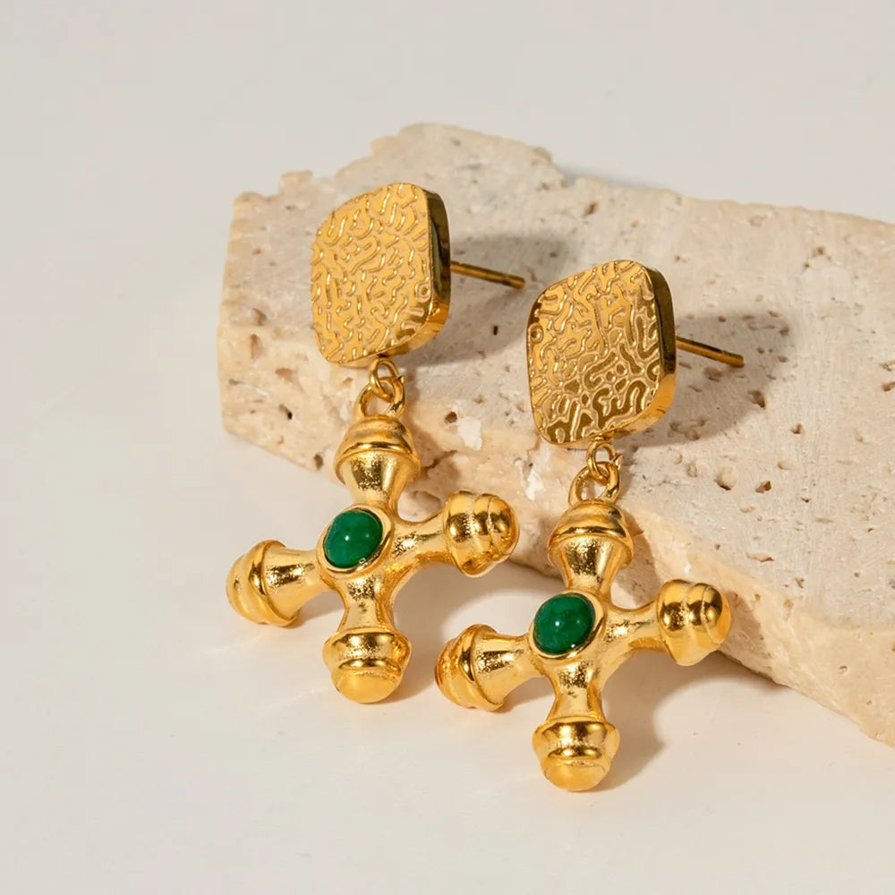 Textured gold-plated cross drop earrings with green stone detail