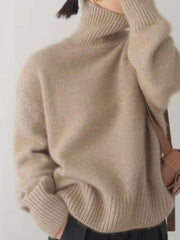 Relaxed fit cashmere turtleneck sweater in khaki with ribbed collar, cuffs, and hem.