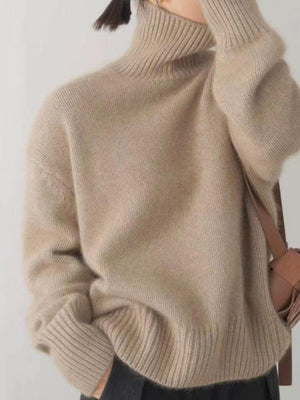 Relaxed fit cashmere turtleneck sweater in khaki with ribbed collar, cuffs, and hem.