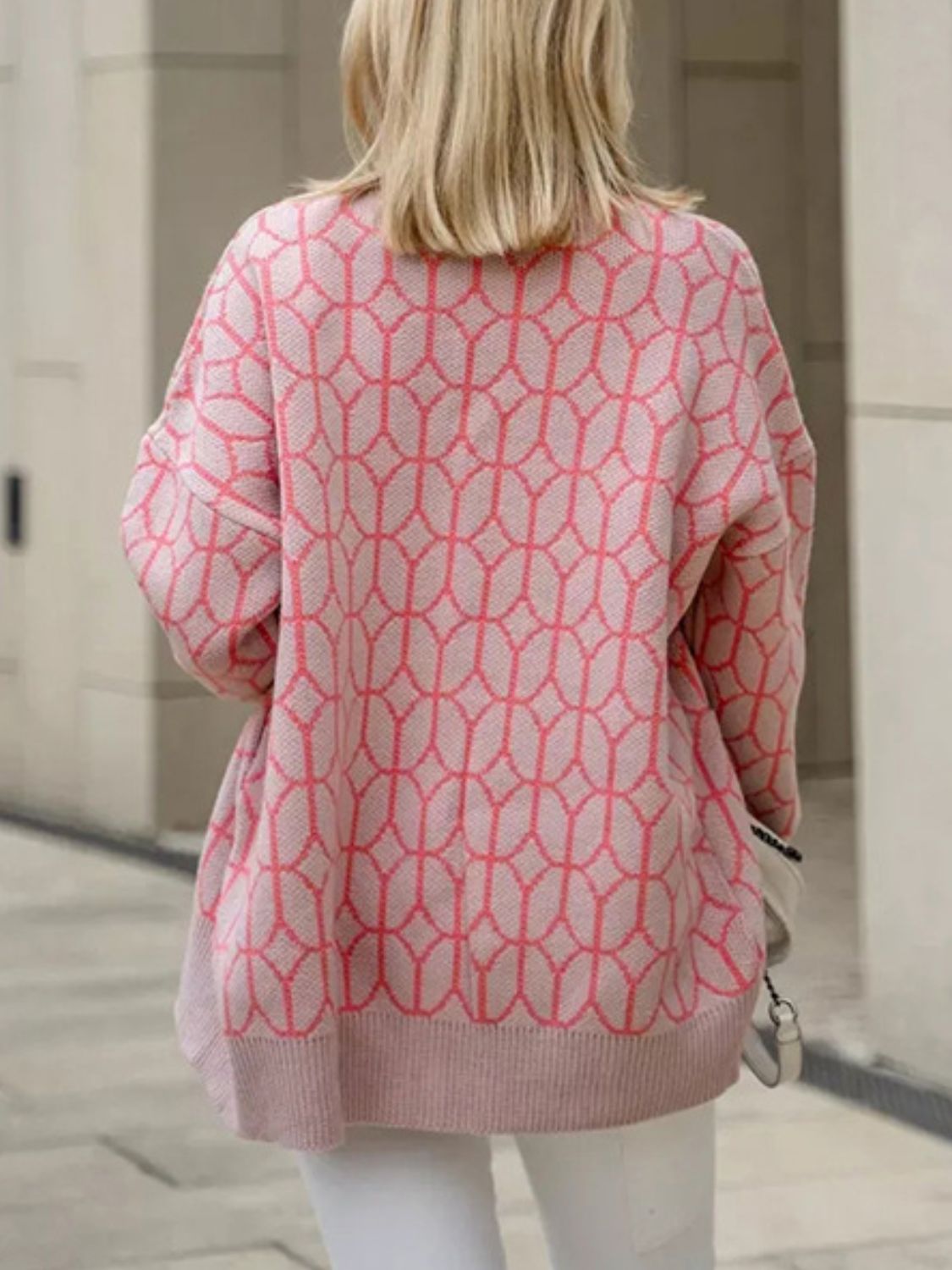 Dusty pink geometric knit button-up cardigan with a coral pattern.