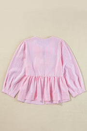 Blush pink striped peplum blouse with long puff sleeves and a ruffled hem.