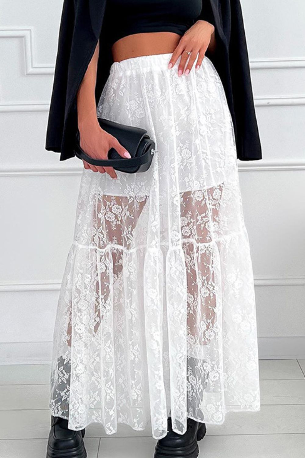 White tiered floral lace maxi skirt with sheer panels and elastic waist.