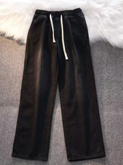 Black vintage wash wide-leg jeans with drawstring and elastic waist.