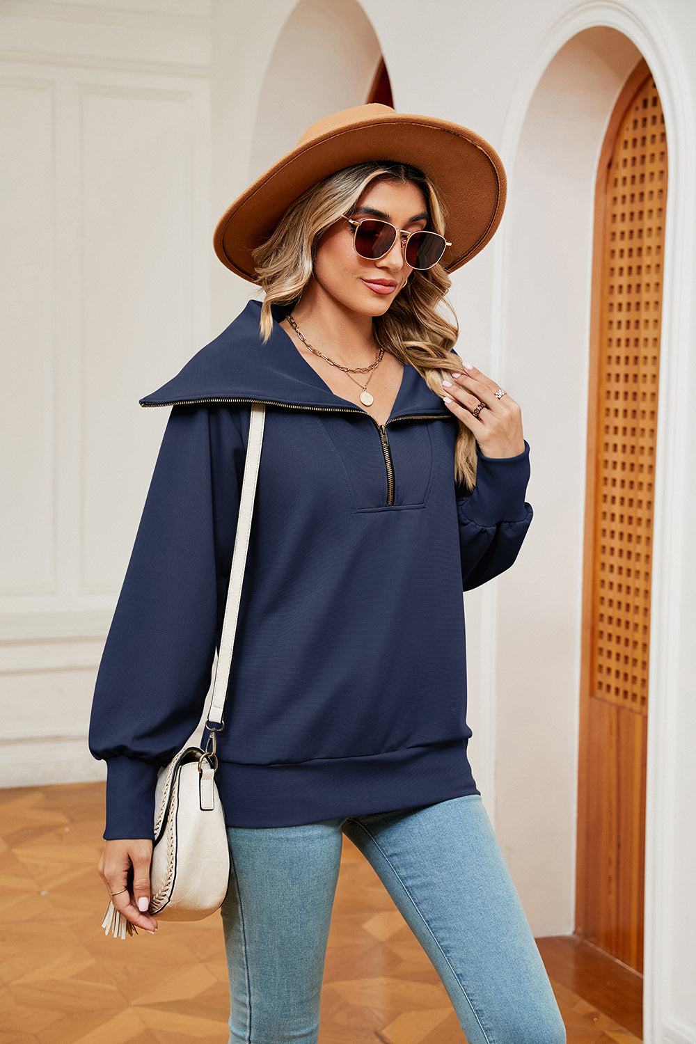 Navy blue wide collar zip-through sweatshirt with balloon sleeves.