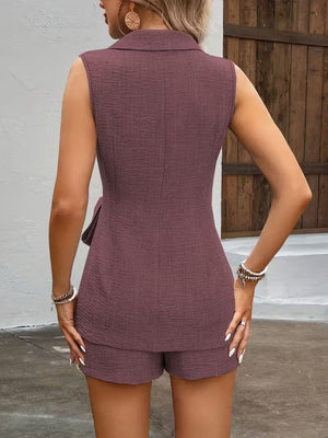 Sleeveless blazer and tailored shorts set in mauve with textured fabric and a tie detail.