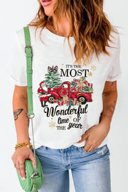 White graphic tee with Christmas truck, tree, Santa, and presents.