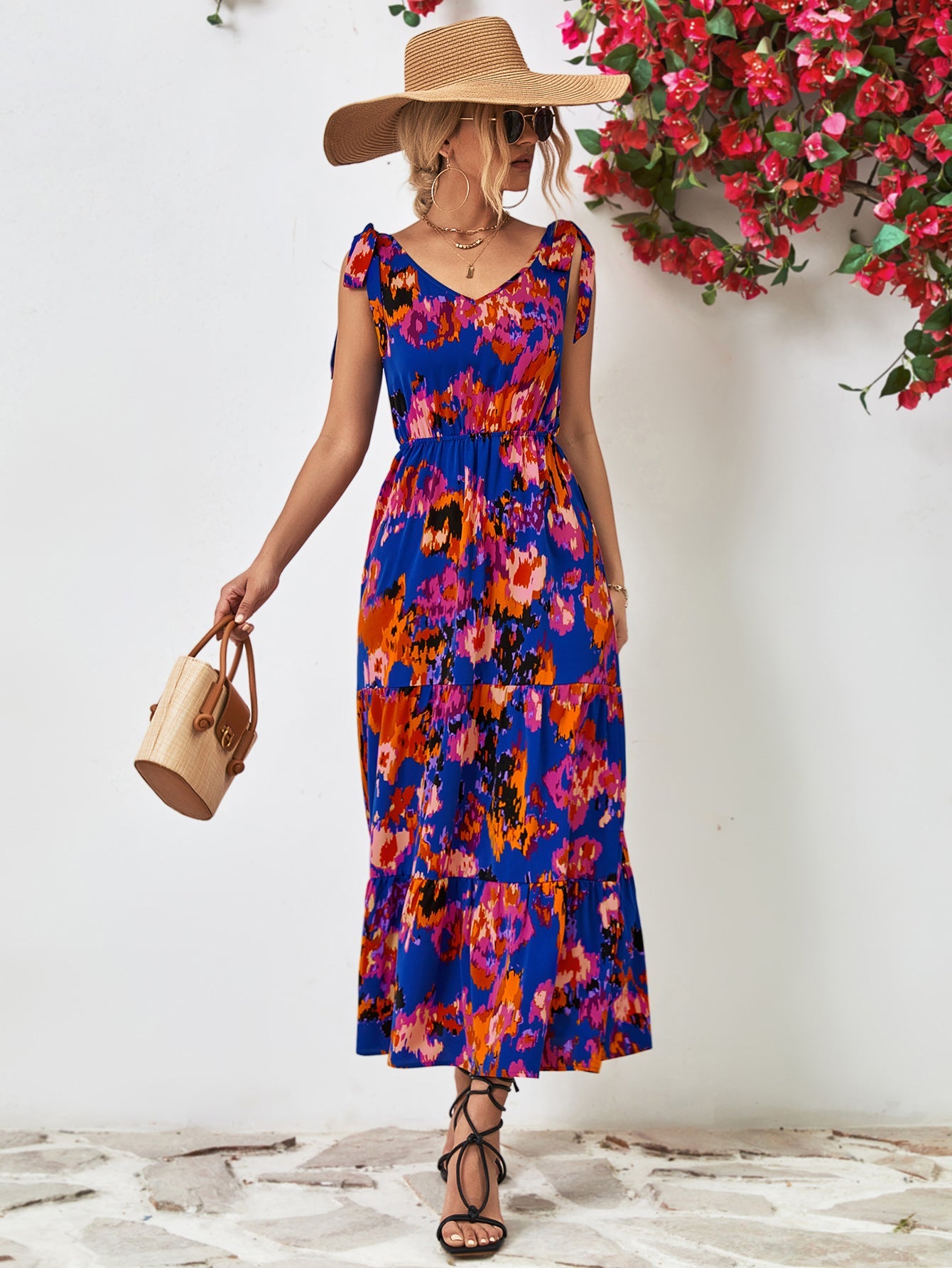 Maxi dress with abstract print, tie straps, and tiered skirt in blue and orange.