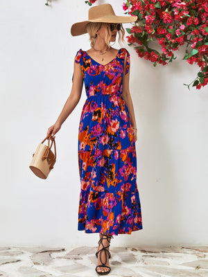 Maxi dress with abstract print, tie straps, and tiered skirt in blue and orange.