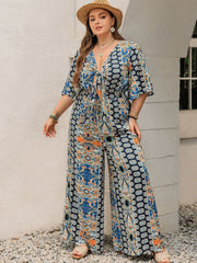 Bohemian palazzo jumpsuit in Peacock Blue with tie-front, V-neck, and bell sleeves.