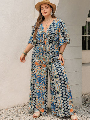 Bohemian palazzo jumpsuit in Peacock Blue with tie-front, V-neck, and bell sleeves.