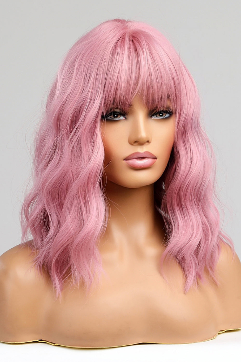 Pink bob wig with bangs and wavy texture