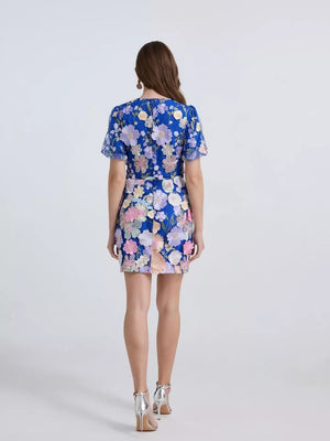 Embroidered floral mini dress in sky blue with puff sleeves and colorful applique flowers.