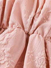 Pink floral embossed baby one-piece with ruffled detail, cotton blend fabric.
