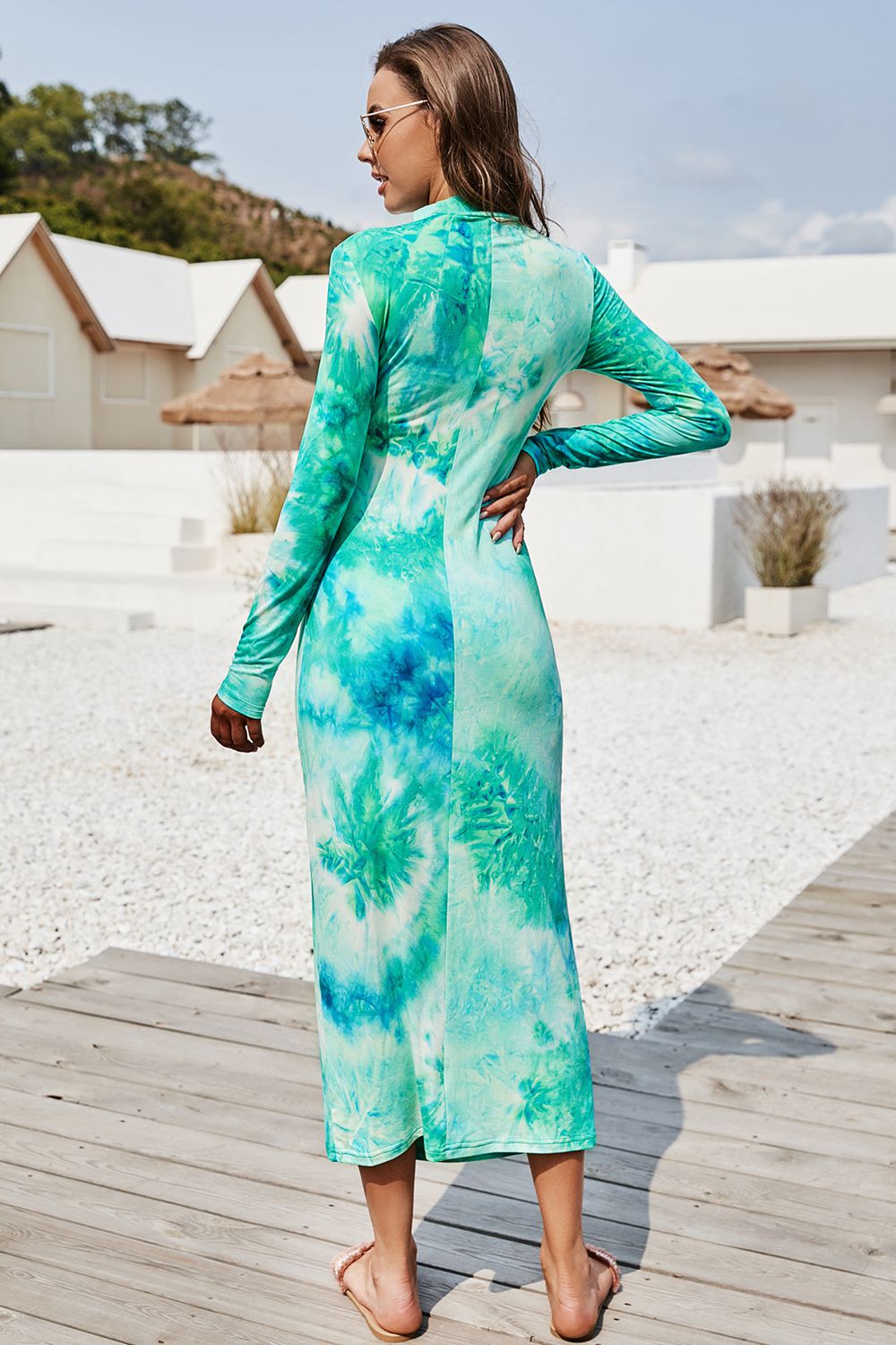 Turquoise tie-dye ruched midi dress with mock neck and long sleeves.