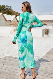 Turquoise tie-dye ruched midi dress with mock neck and long sleeves.