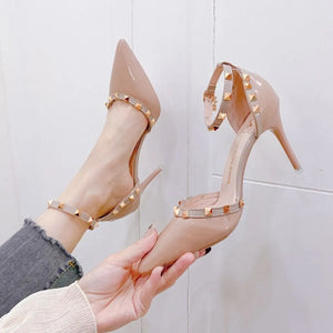 Apricot patent pumps with studded ankle straps and pointed toe.