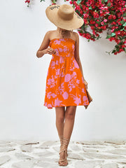 Orange floral smocked bandeau mini dress with drawstring waist and ruffled hem.