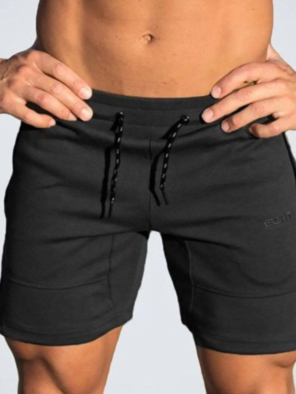 Black performance fit training shorts with drawstring and subtle logo detail.