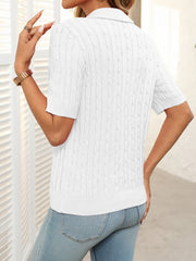 White cable knit polo sweater with short sleeves and a collar.