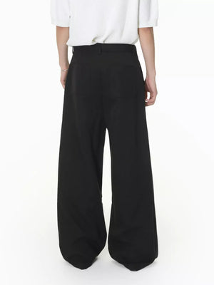 Black wide-leg pleated sweatpants with a belted waist and two back pockets.