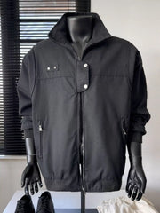 Black casual bomber jacket with zip front, stand collar, and buttoned flap details.