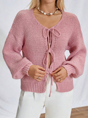 Dusty pink knit cardigan with balloon sleeves and lace-up front detail.
