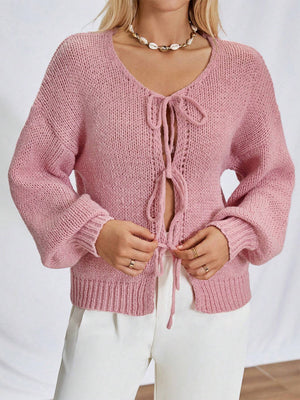 Dusty pink knit cardigan with balloon sleeves and lace-up front detail.