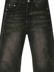 Faded wash bootcut jeans in dark denim with green paint-splatter details.