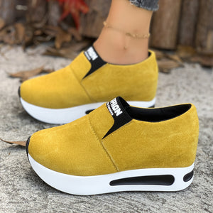 Yellow suede round toe platform slip-on sneakers with white soles and black trim.