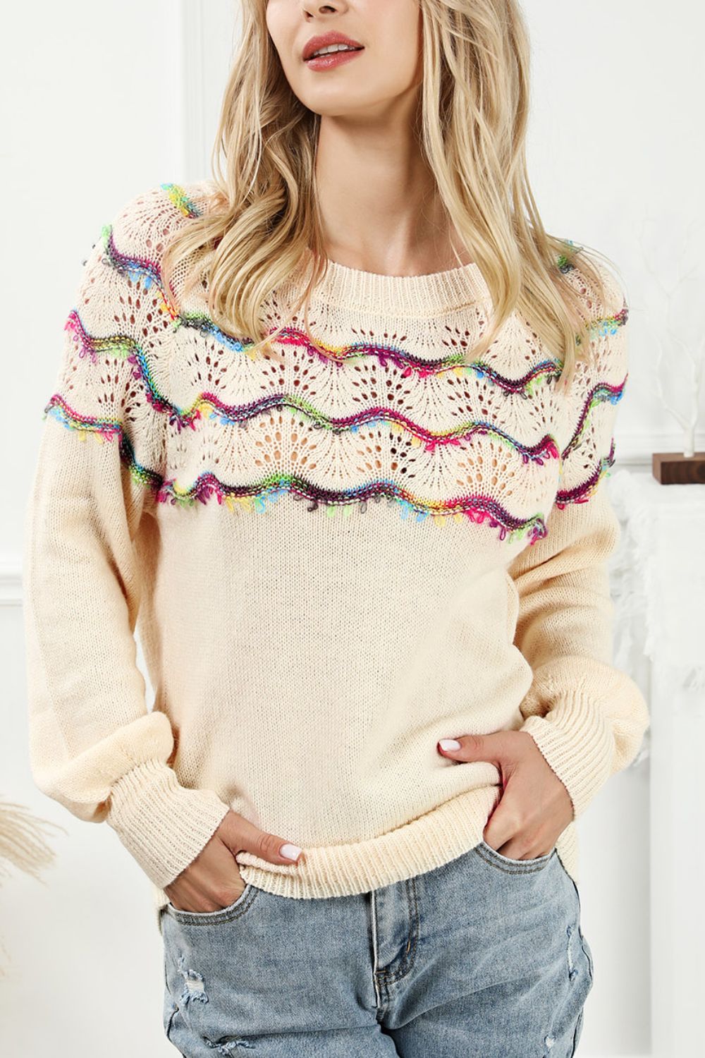Cream acrylic sweater with rainbow scallop detail and open knit yoke.