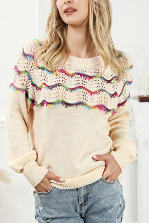 Cream acrylic sweater with rainbow scallop detail and open knit yoke.
