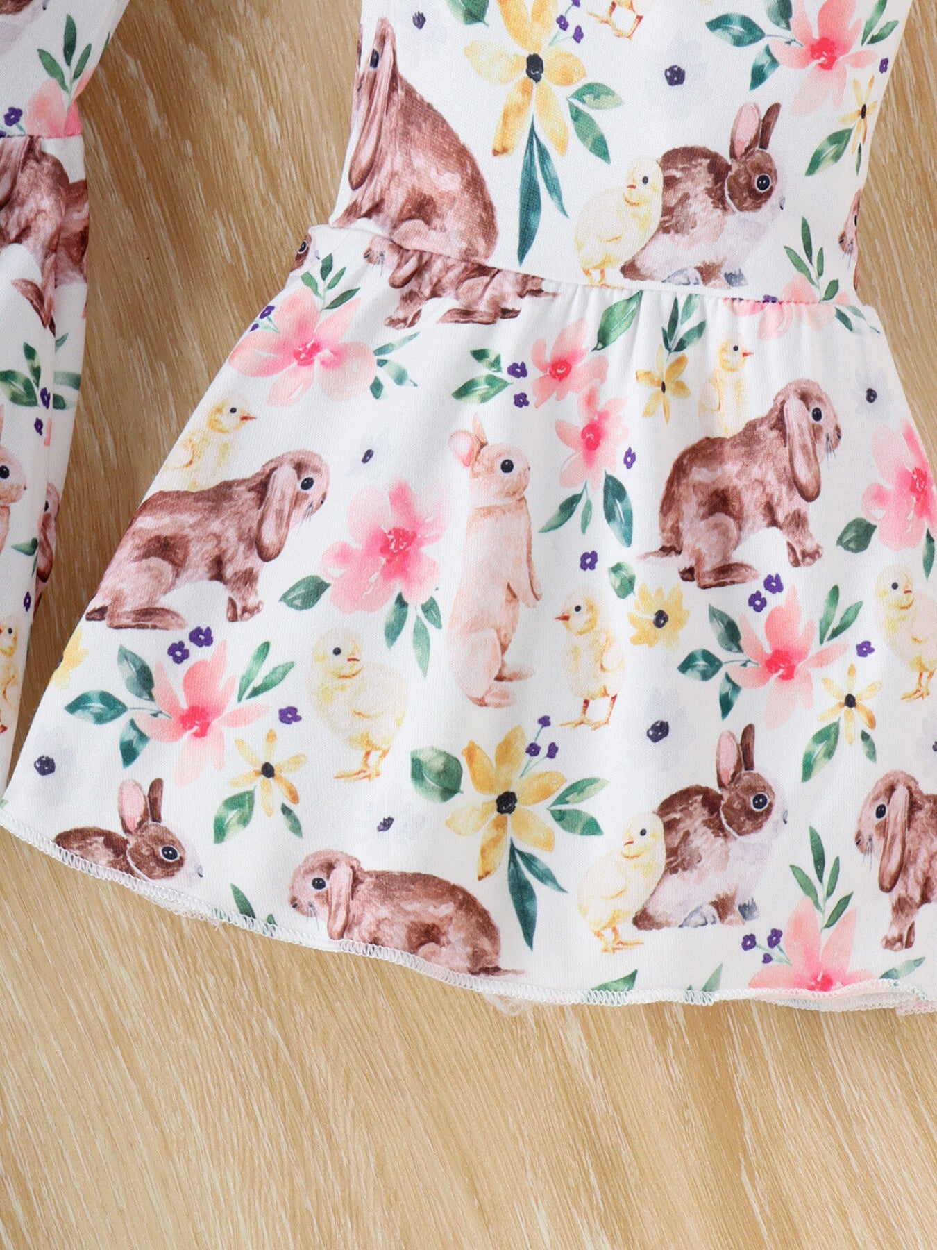 Baby set with white fabric, bunny and chick print, and floral accents.