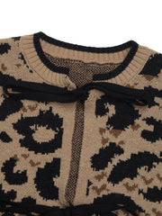 Tan leopard print acrylic knit cardigan with black bow-tie detail at neckline