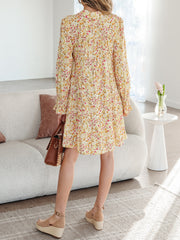 Floral print loose shirt dress with button-down front and ruffled cuffs.