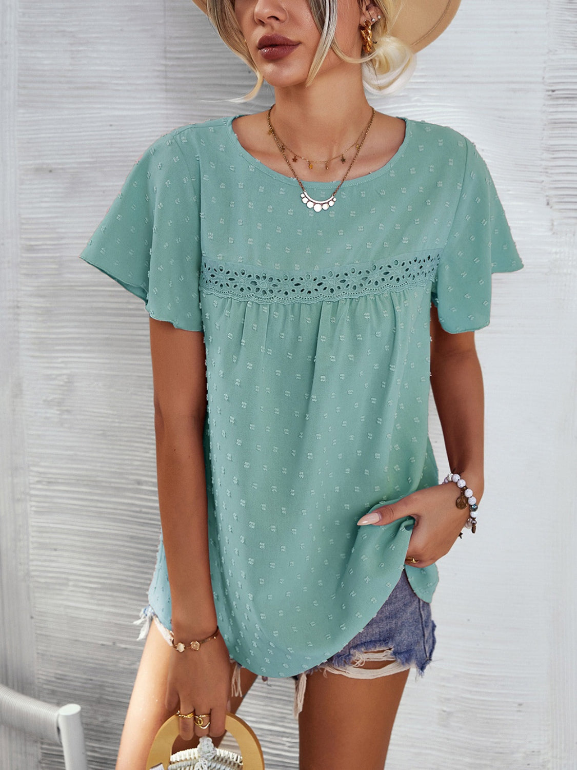 Light green Swiss dot blouse with flutter sleeves and eyelet detail.