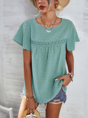 Light green Swiss dot blouse with flutter sleeves and eyelet detail.