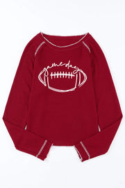 Burgundy waffle knit crewneck top with white "game day" football graphic and contrast stitching.