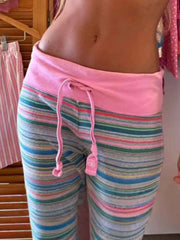 Relaxed drawstring joggers with pink waistband and multi-color stripes.
