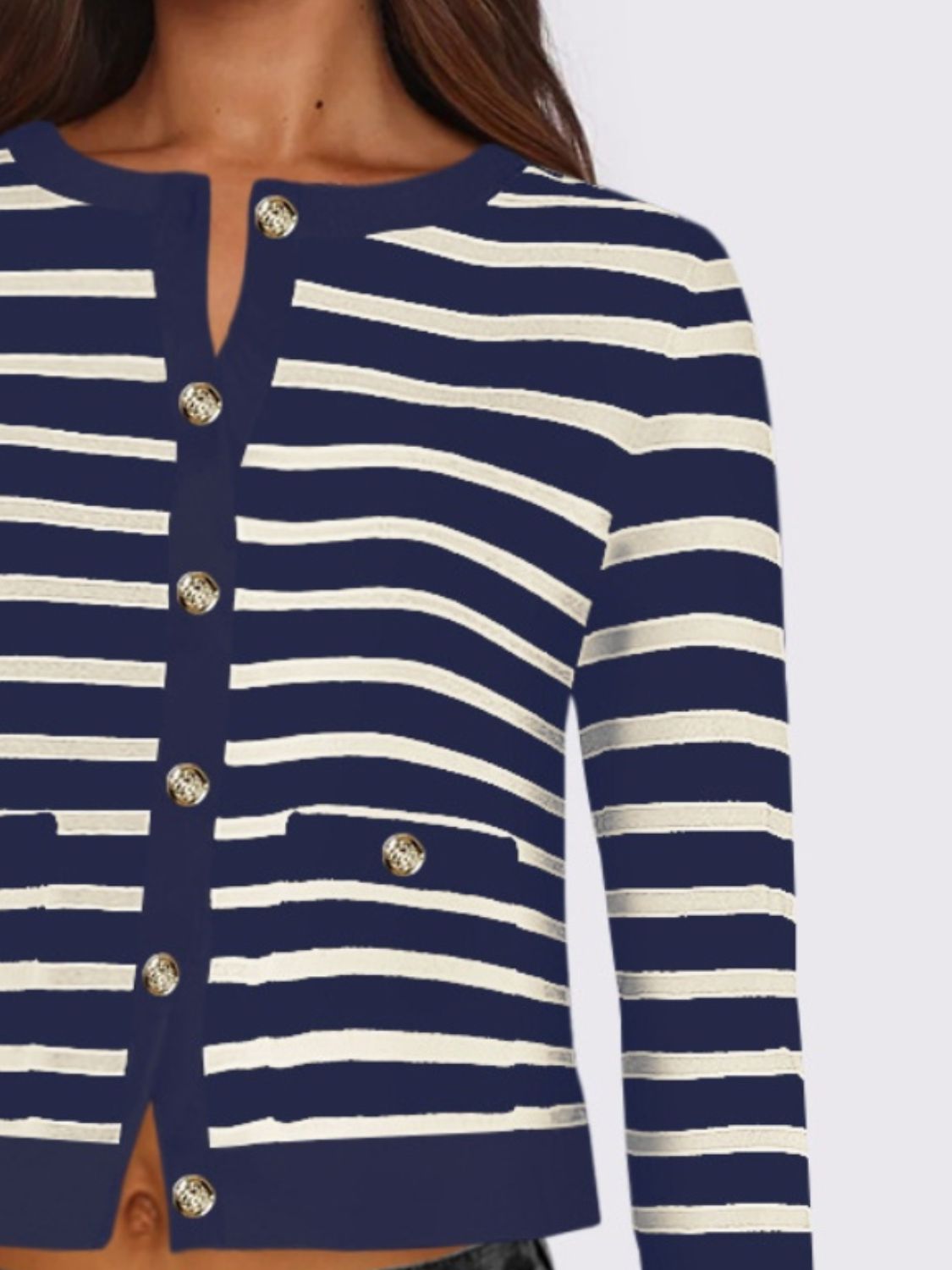 Navy and white striped cropped cardigan with gold buttons and pockets.