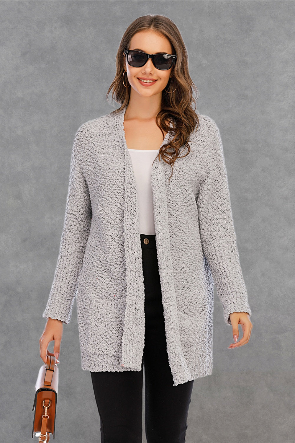 Light gray textured cocoon cardigan with patch pockets and open front.