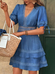 Blue lace-embellished V-neck mini dress with tiered skirt and tie sleeves.